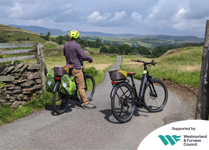 A person with an ebike looking at a view of a sunny landscape near Staveley