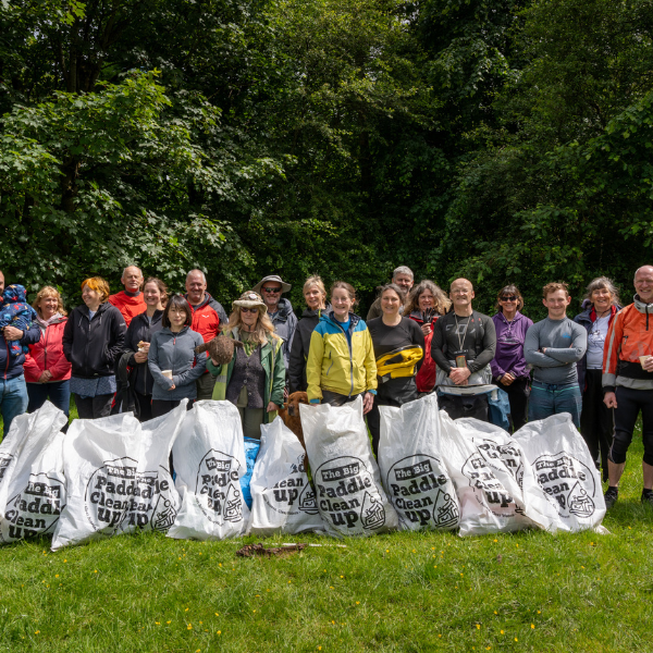 A group of around 30 people behind bags of litter picked up at the Great Big Green Week river clean up